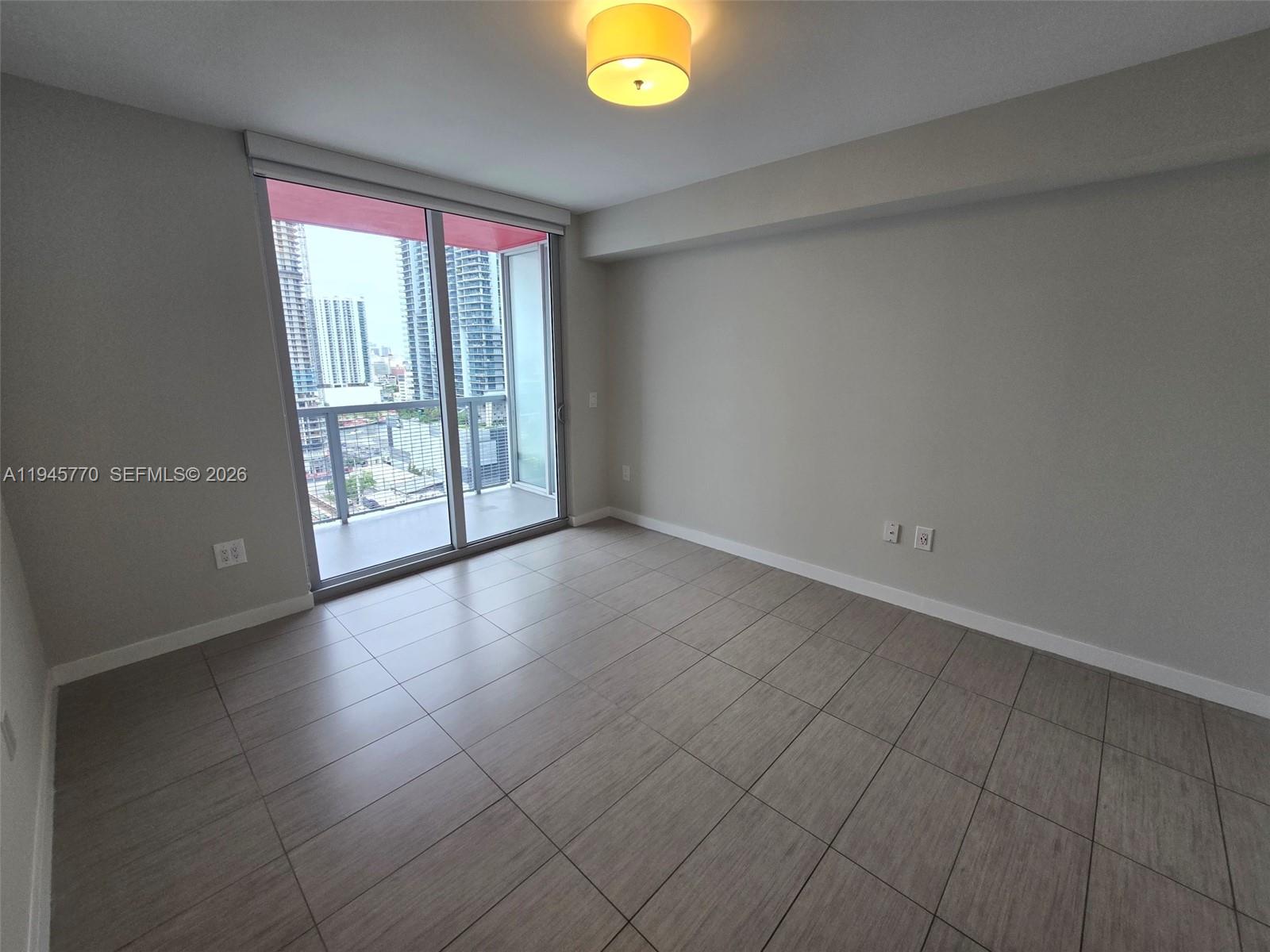 117 Southwest 10th Street, Unit 2206 Miami, FL 33130 - Photo 15 of 22 wooden floor in an empty room with a window