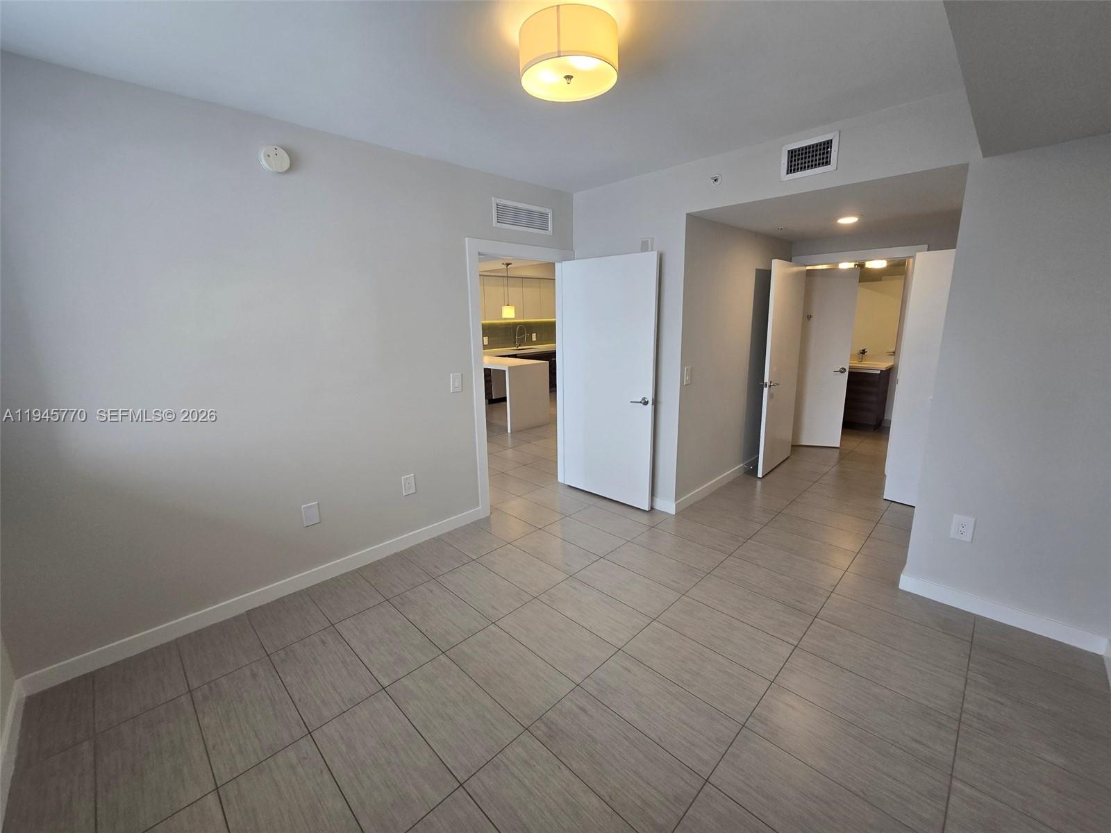 117 Southwest 10th Street, Unit 2206 Miami, FL 33130 - Photo 18 of 22 wooden floor in an empty room and a window