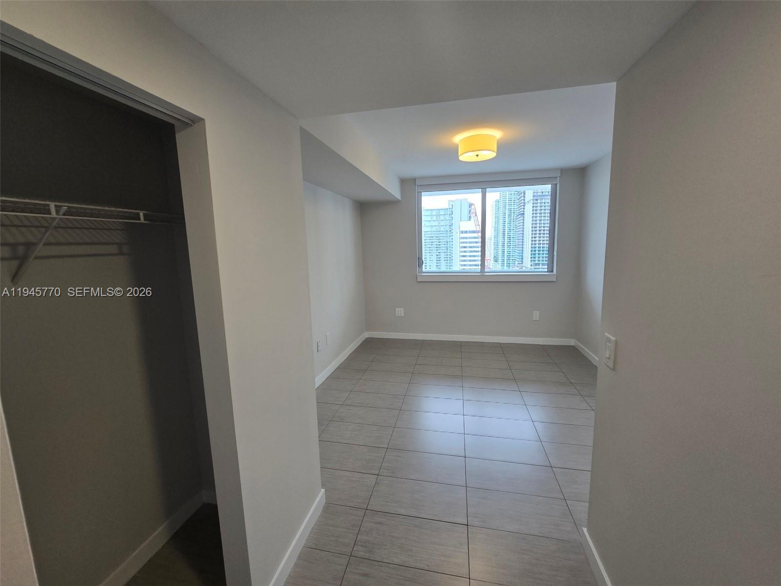 117 Southwest 10th Street, Unit 2206 Miami, FL 33130 - Photo 20 of 22 a view of an empty room with window and bathroom