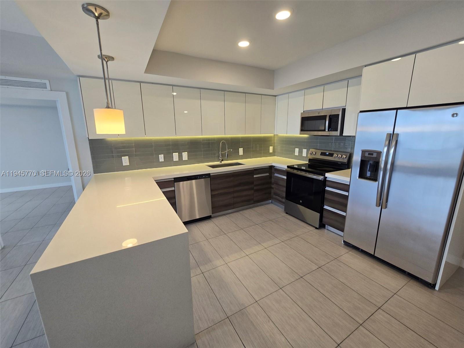 117 Southwest 10th Street, Unit 2206 Miami, FL 33130 - Photo 10 of 22 a kitchen with stainless steel appliances granite countertop a sink counter space cabinets and stainless steel appliances