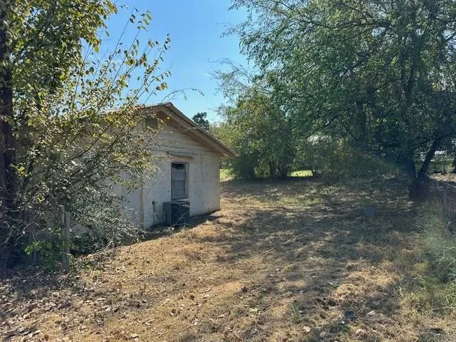 a backyard of a house with large trees