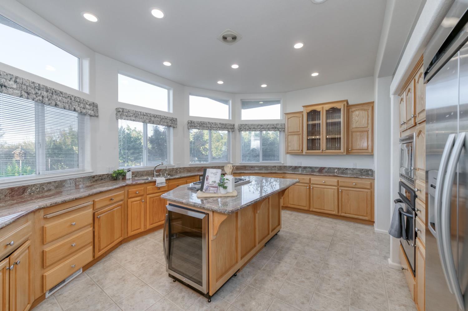 8646 Cairo Avenue Laton, CA 93242 - Photo 11 of 38 a large kitchen with stainless steel appliances granite countertop a large stove top oven and cabinets