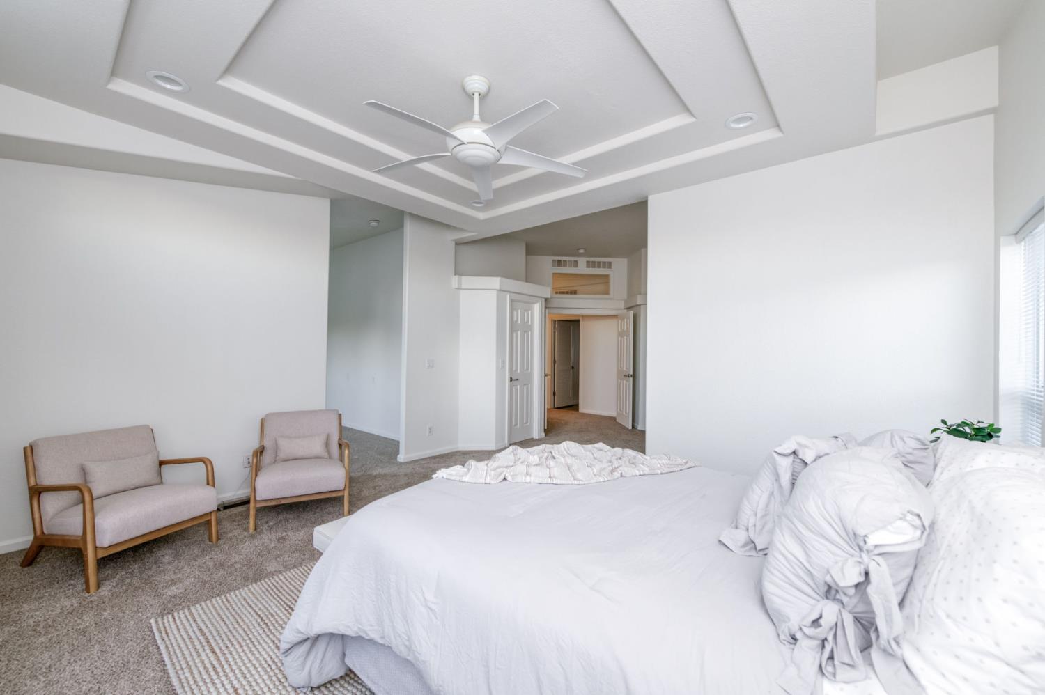 8646 Cairo Avenue Laton, CA 93242 - Photo 14 of 38 a bedroom with a bed and a chandelier