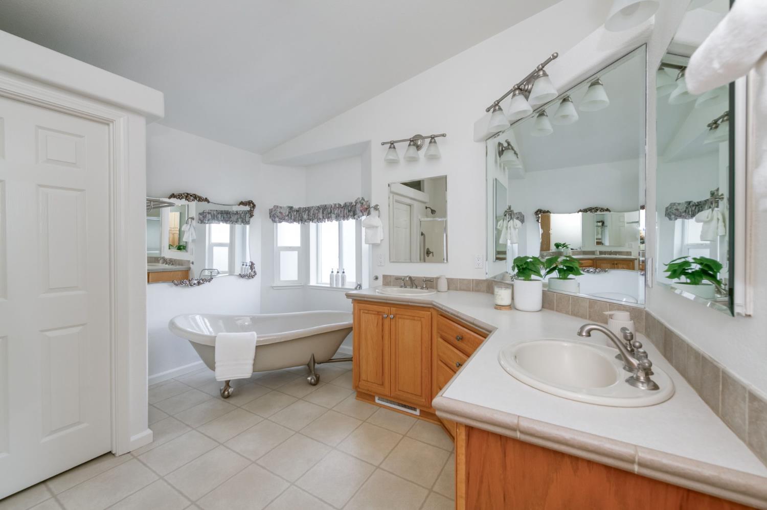 8646 Cairo Avenue Laton, CA 93242 - Photo 17 of 38 a bathroom with a sink tub double vanity and a mirror