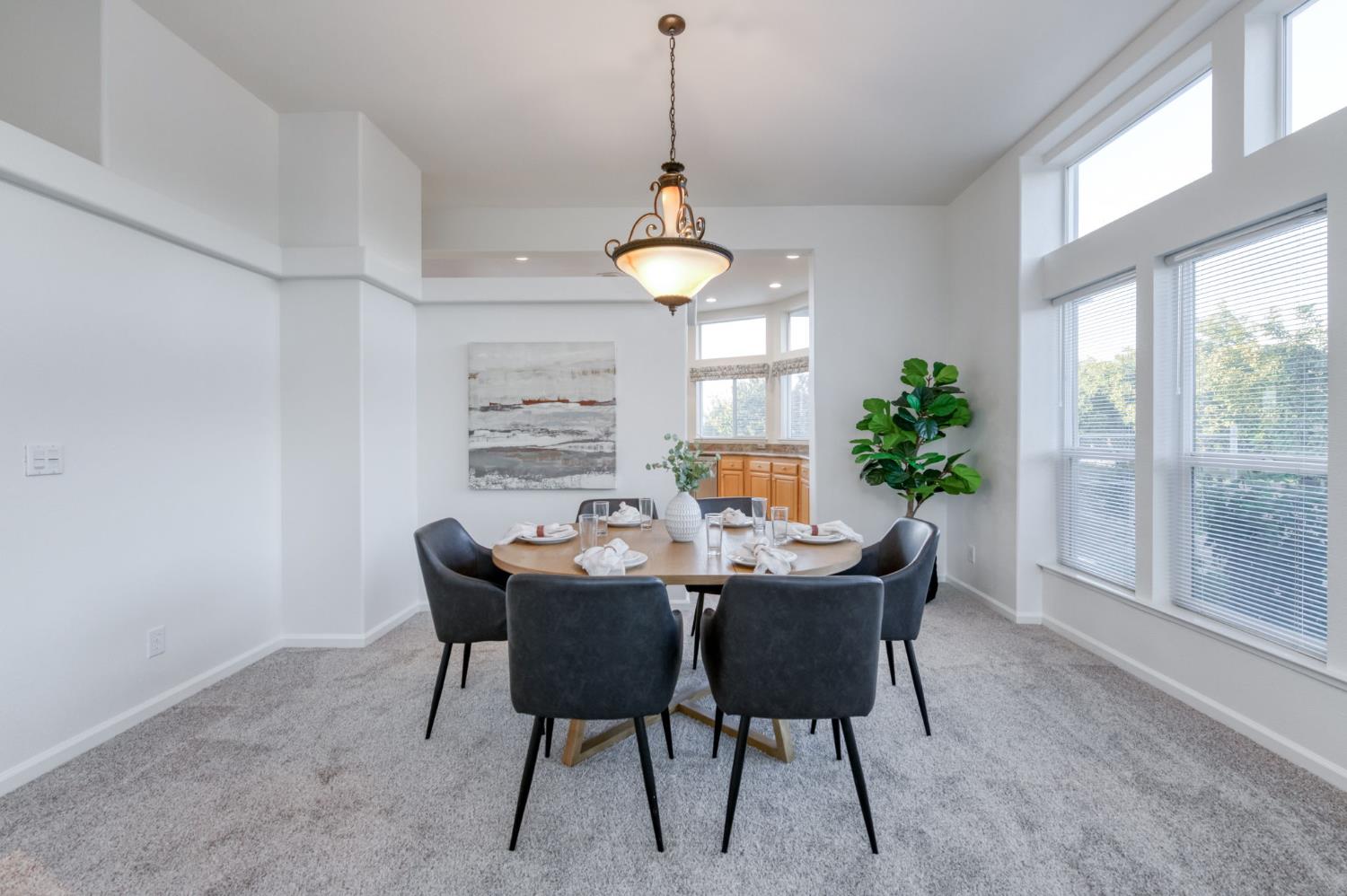 8646 Cairo Avenue Laton, CA 93242 - Photo 8 of 38 a dining room with furniture a window and a chandelier