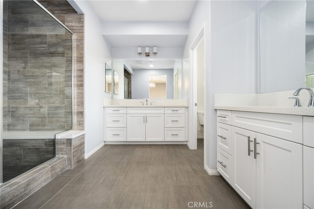 94 Capricorn Irvine, CA 92618 - Photo 19 of 47 a bathroom with a sink a mirror and shower