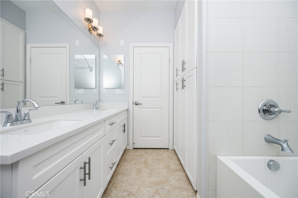 94 Capricorn Irvine, CA 92618 - Photo 23 of 47 a spacious bathroom with a double vanity sink a mirror and a bathtub