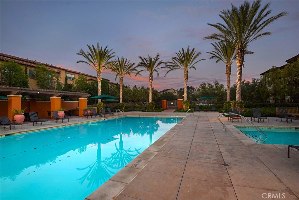 94 Capricorn Irvine, CA 92618 - Photo 33 of 47 a view of swimming pool with a patio and a yard