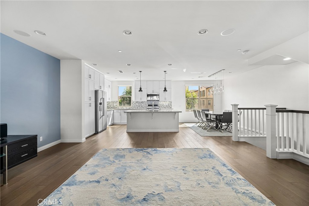 94 Capricorn Irvine, CA 92618 - Photo 4 of 47 a living room with stainless steel appliances furniture a rug and a view of kitchen