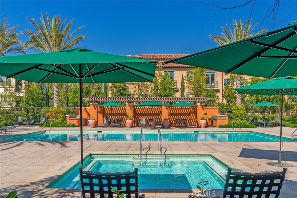 94 Capricorn Irvine, CA 92618 - Photo 43 of 47 a view of a yard with table and chairs under an umbrella