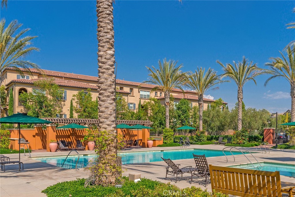 94 Capricorn Irvine, CA 92618 - Photo 45 of 47 a view of a swimming pool with a lawn chairs and a yard