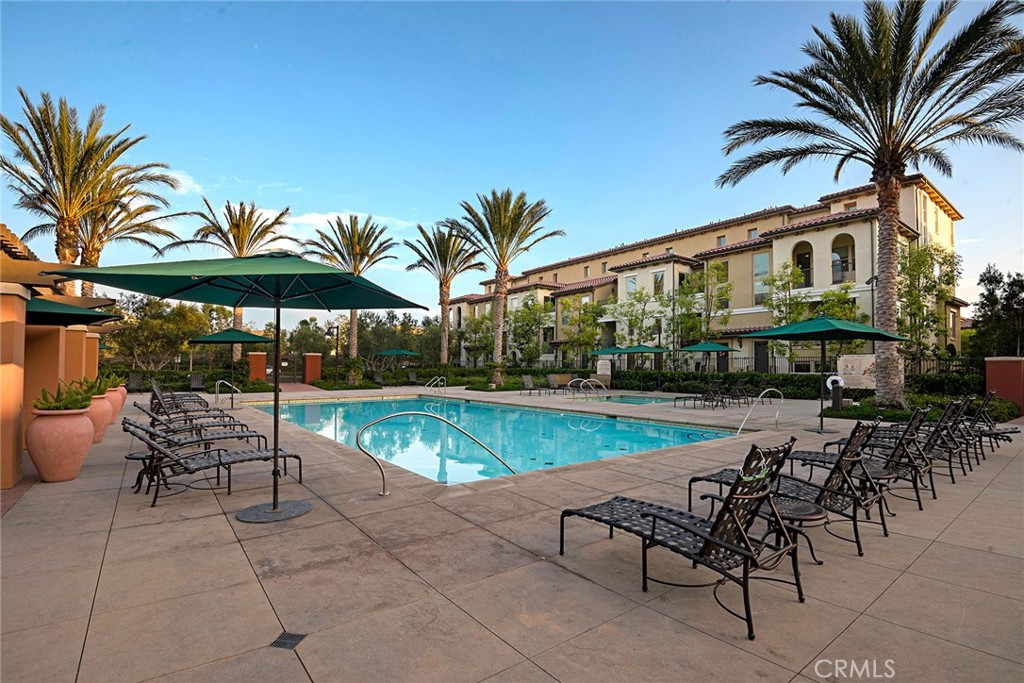 94 Capricorn Irvine, CA 92618 - Photo 46 of 47 a view of a swimming pool with chairs in patio