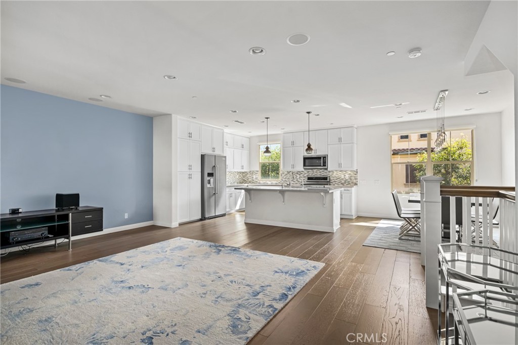 94 Capricorn Irvine, CA 92618 - Photo 5 of 47 a large white kitchen with wooden floor and a refrigerator