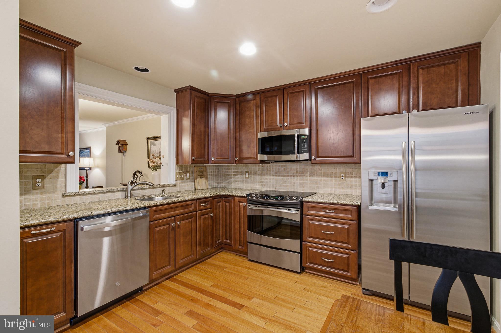 134 Spring Pl Way Annapolis, MD 21401 - Photo 19 of 59 a kitchen with stainless steel appliances granite countertop a sink stove and refrigerator