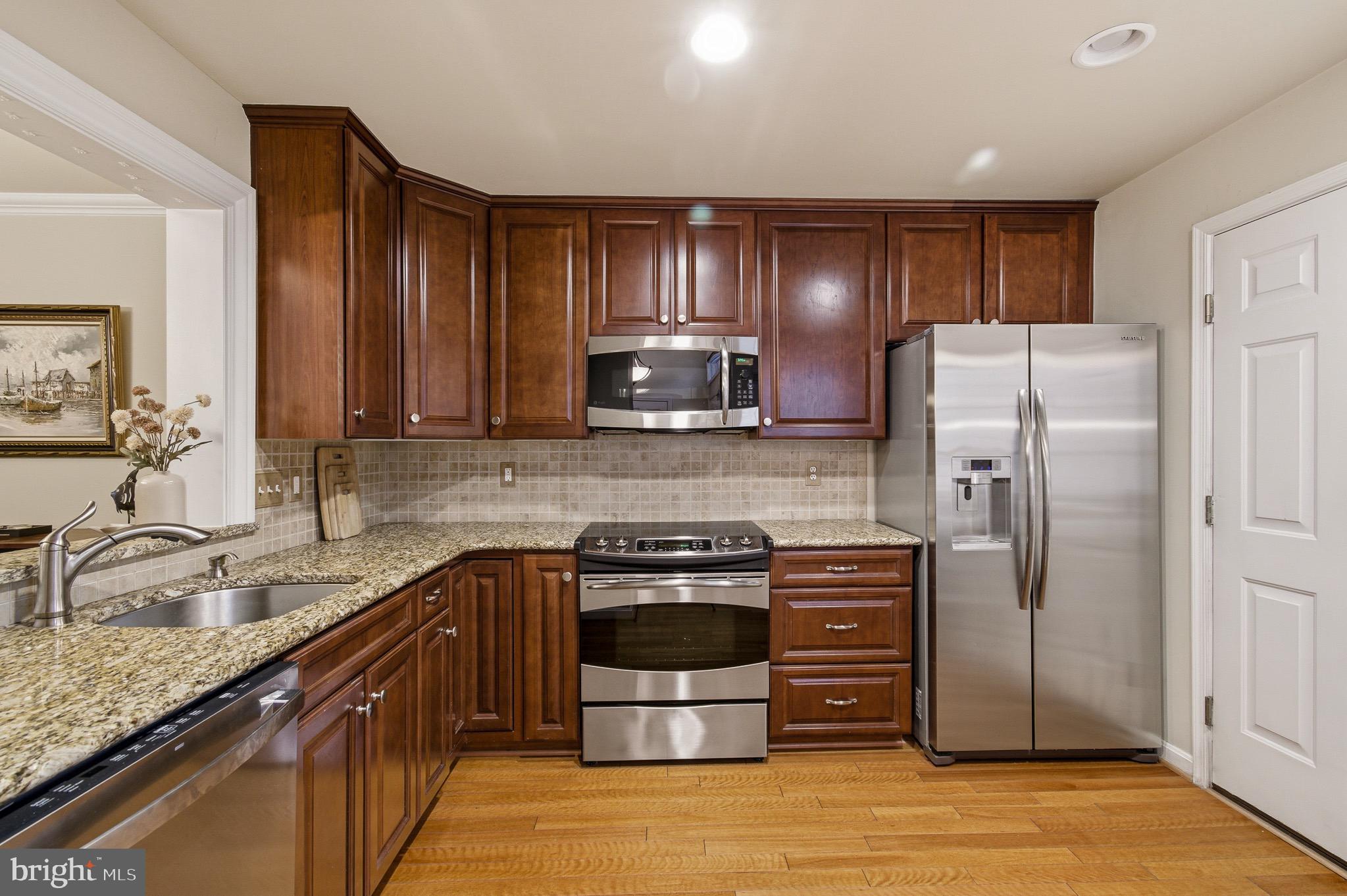 134 Spring Pl Way Annapolis, MD 21401 - Photo 20 of 59 a kitchen with stainless steel appliances granite countertop a stove a refrigerator and a sink