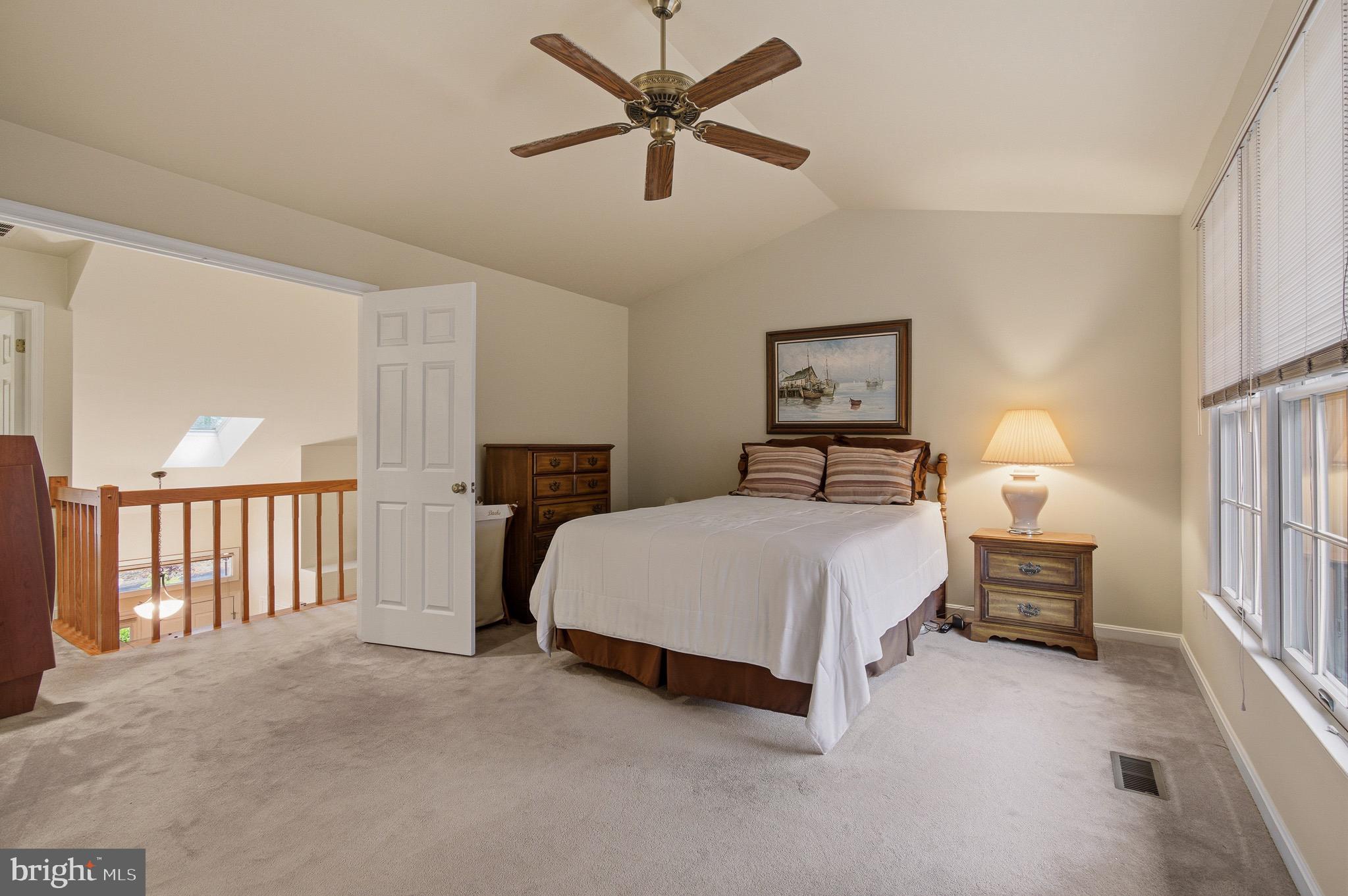 134 Spring Pl Way Annapolis, MD 21401 - Photo 31 of 59 a bedroom with a bed a lamp and a chandelier