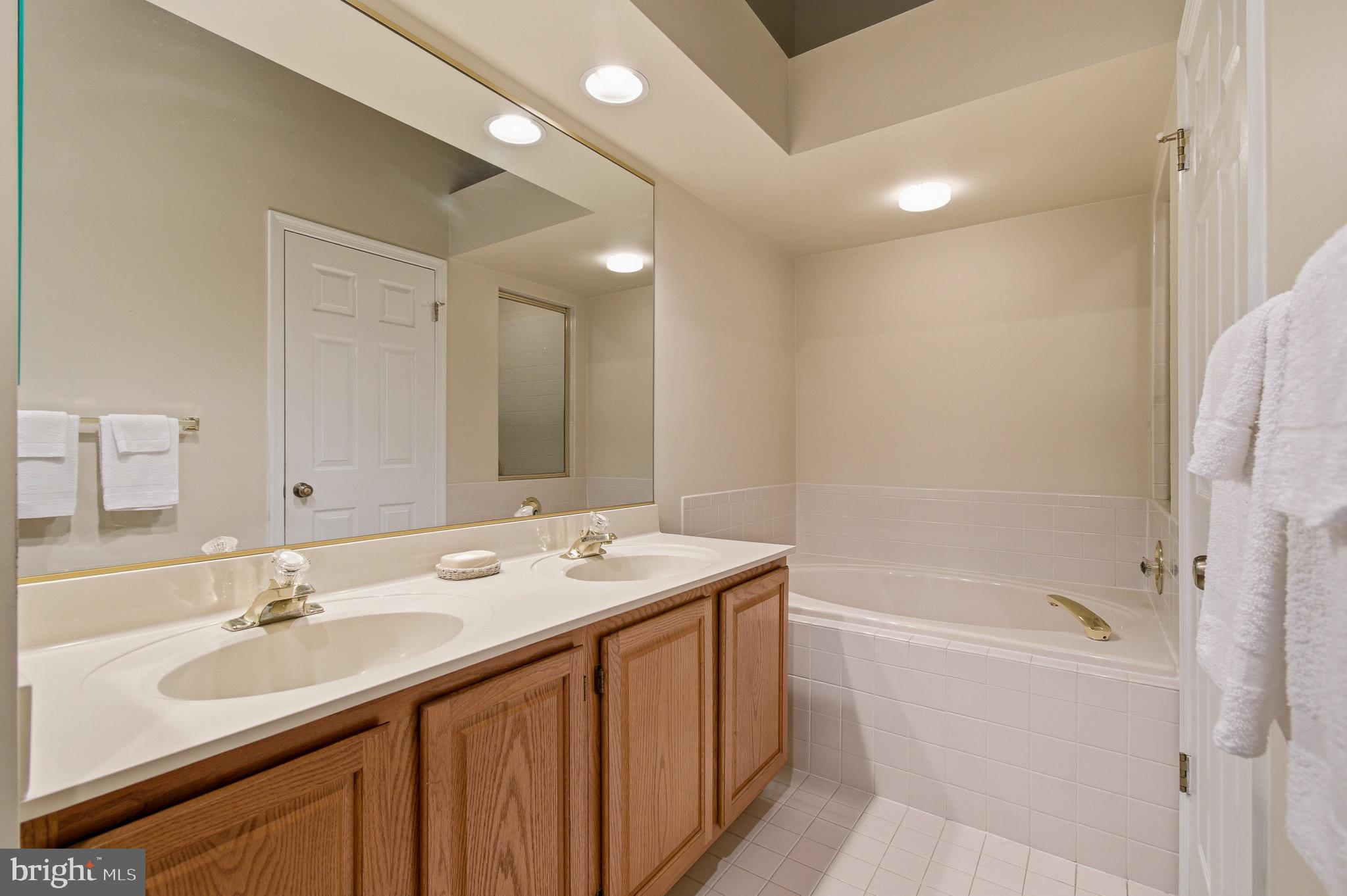 134 Spring Pl Way Annapolis, MD 21401 - Photo 34 of 59 a bathroom with a sink double vanity granite tub shower and a mirror