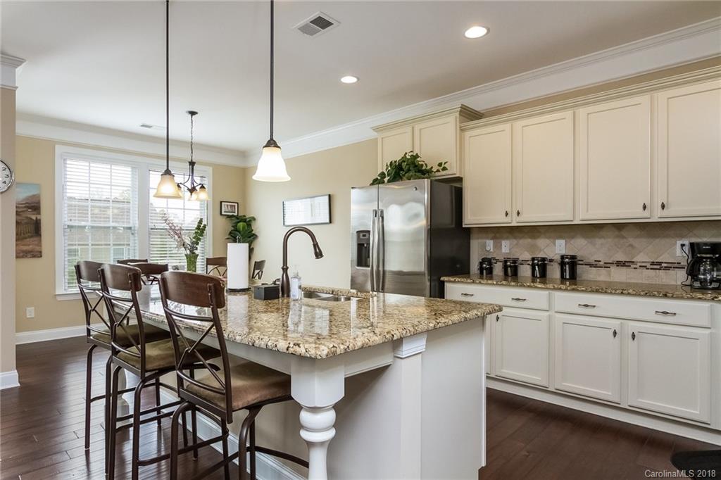 1841 Larkspur Way Tega Cay, SC 29708 - Photo 16 of 27 a kitchen with refrigerator and cabinets