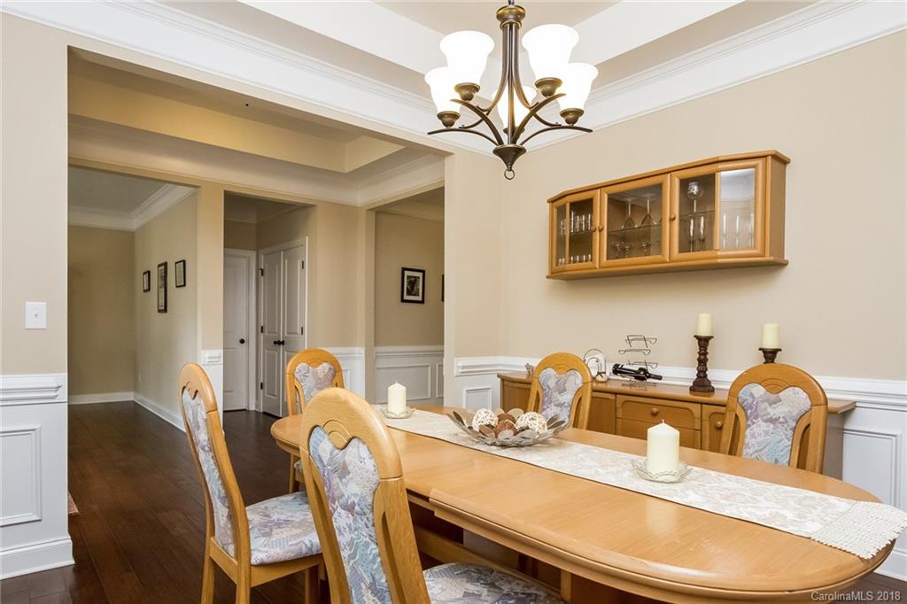 1841 Larkspur Way Tega Cay, SC 29708 - Photo 5 of 27 a view of a dining room with furniture a chandelier and wooden floor