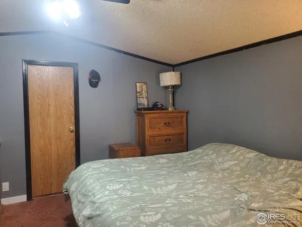 a bedroom with a bed and a lamp on table