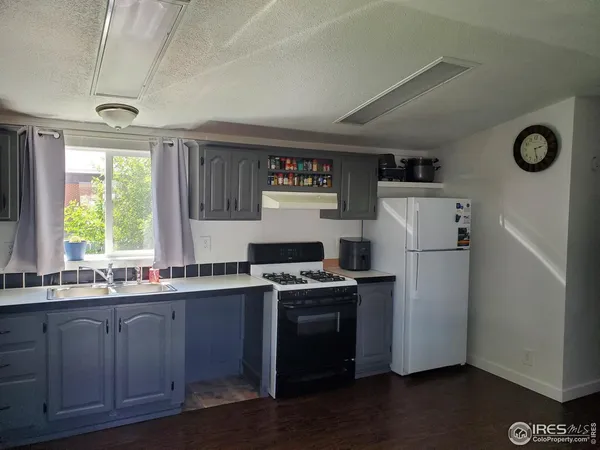 a view of a room with a window and wooden floor