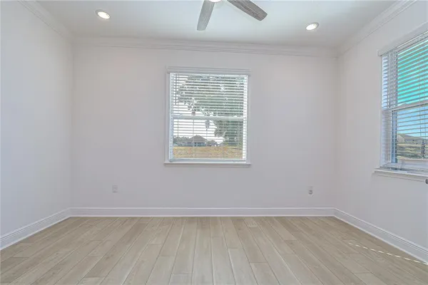 wooden floor in a room with a ceiling fan
