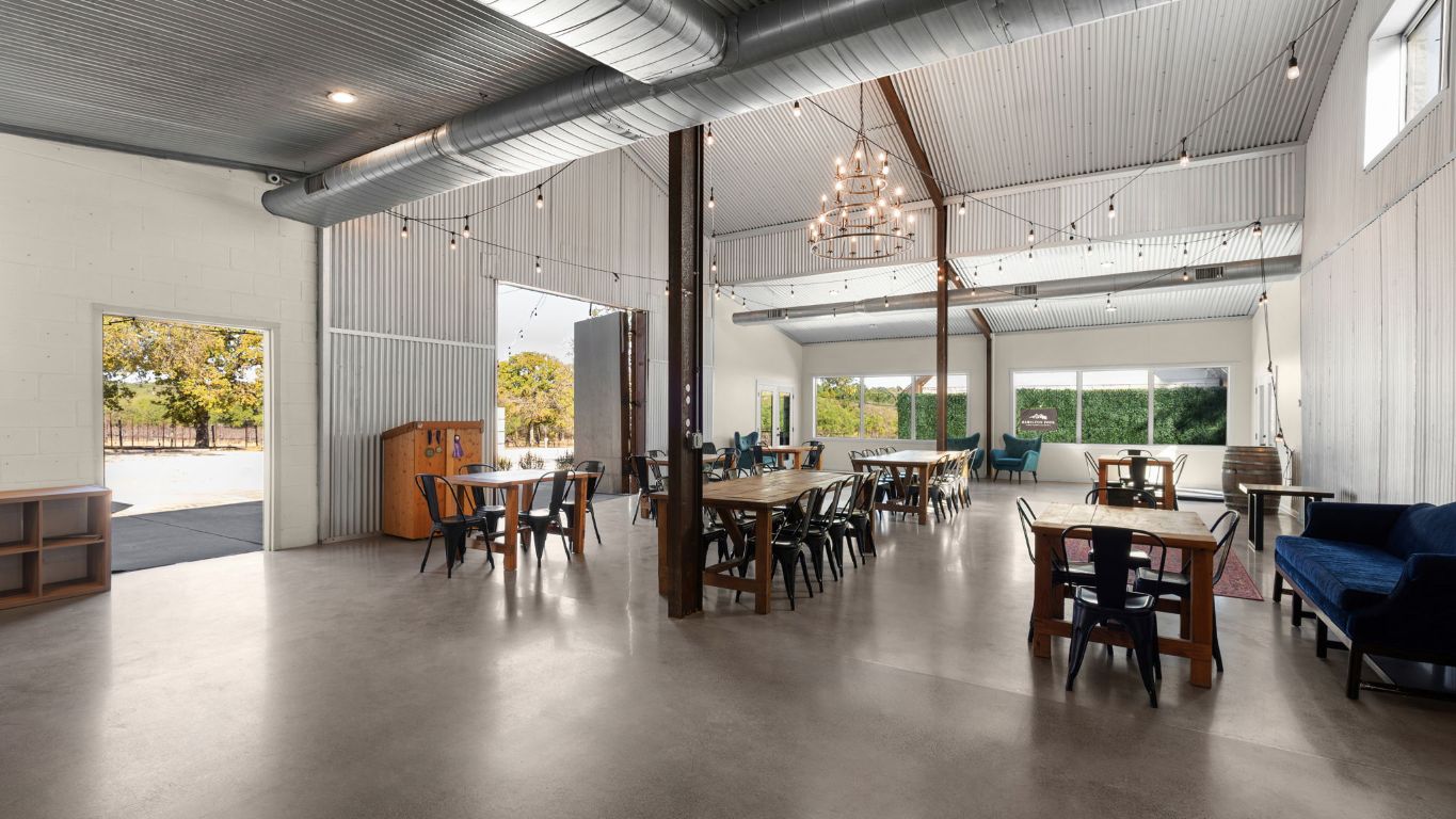 25711 Hamilton Pool Road Round Mountain, TX 78663 - Photo 11 of 40 a view of a dining room with furniture window and wooden floor