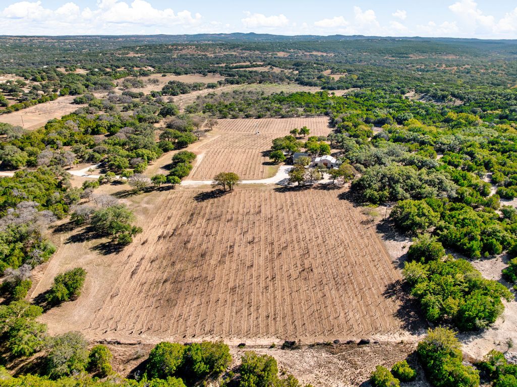 25711 Hamilton Pool Road Round Mountain, TX 78663 - Photo 26 of 40 an aerial view of a house with a yard