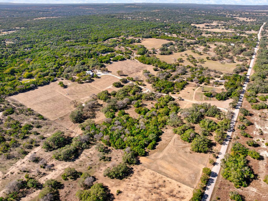 25711 Hamilton Pool Road Round Mountain, TX 78663 - Photo 28 of 40 an aerial view of residential houses with outdoor space and trees