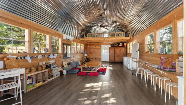 a backyard of a house with lots of green space and fountain