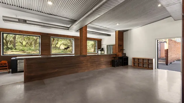 an empty room with furniture and windows