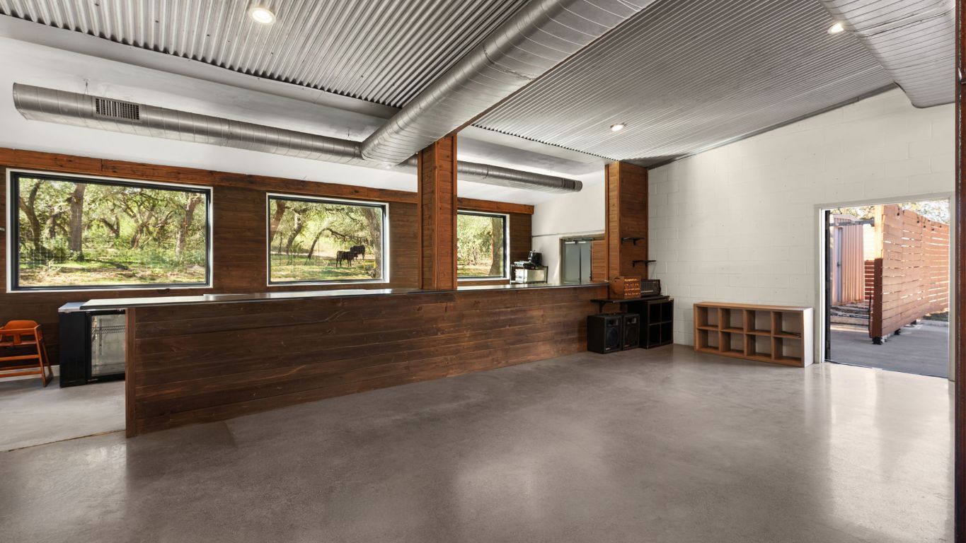 25711 Hamilton Pool Road Round Mountain, TX 78663 - Photo 10 of 40 an empty room with furniture and windows