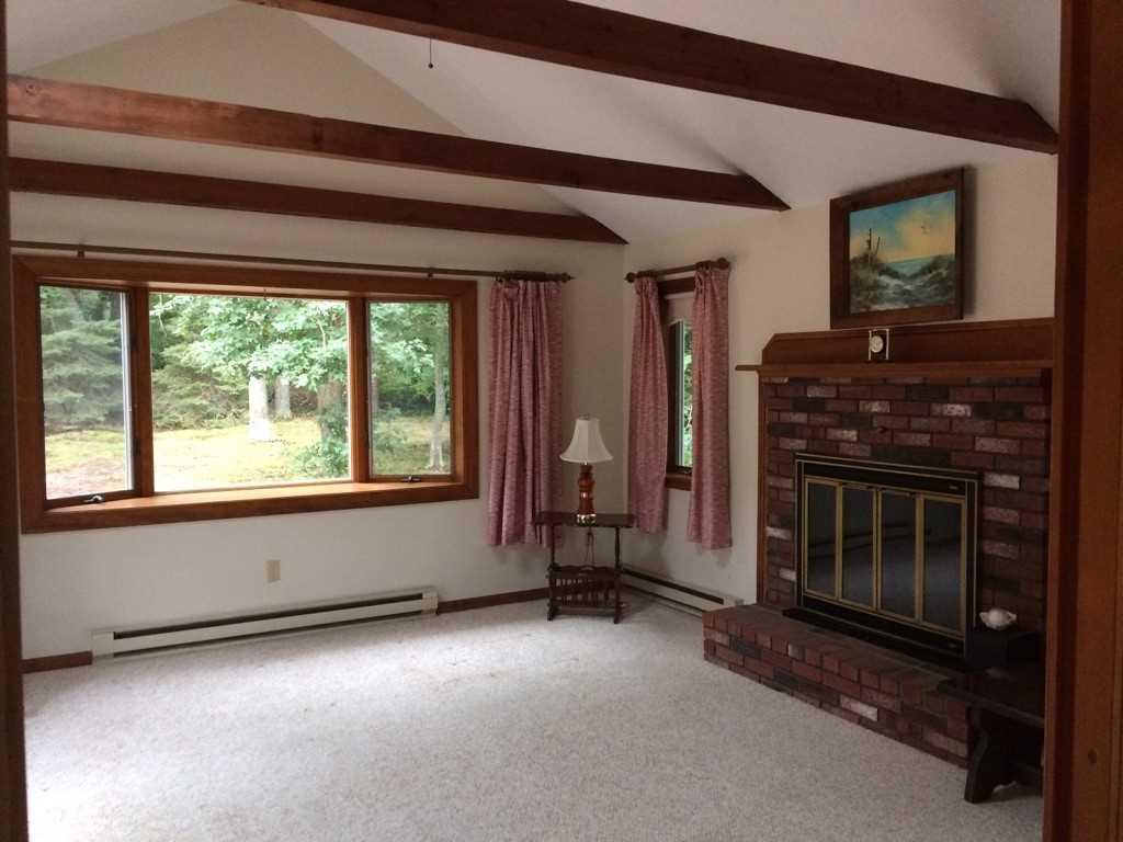 30 Lumbert Mill Road Centerville, MA 02632 - Photo 11 of 19 a view of an empty room with a fireplace and a window