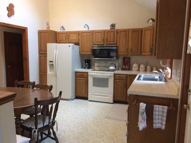 30 Lumbert Mill Road Centerville, MA 02632 - Photo 8 of 19 a kitchen with a sink a stove and chairs