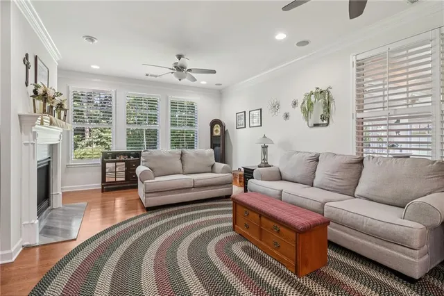 a view of a dining room with furniture a chandelier and wooden floor