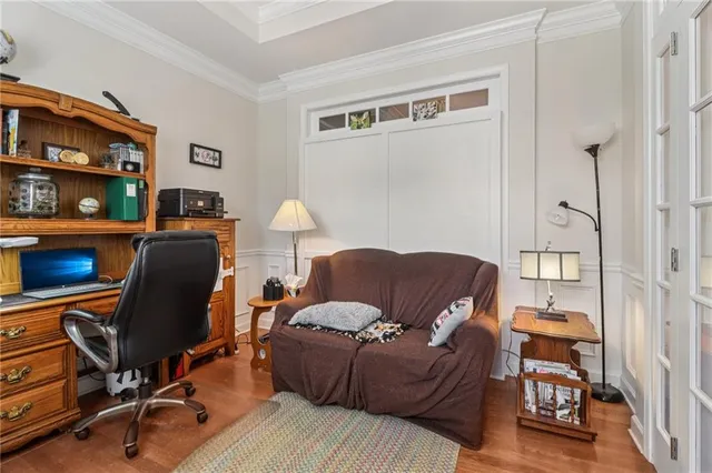 a view of a workspace with furniture and a window