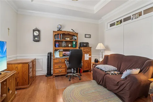 a bedroom with a bed gym equipment and a large window