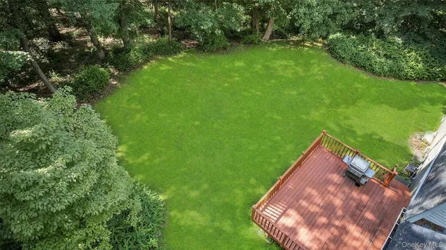 an aerial view of residential house with outdoor space and trees all around