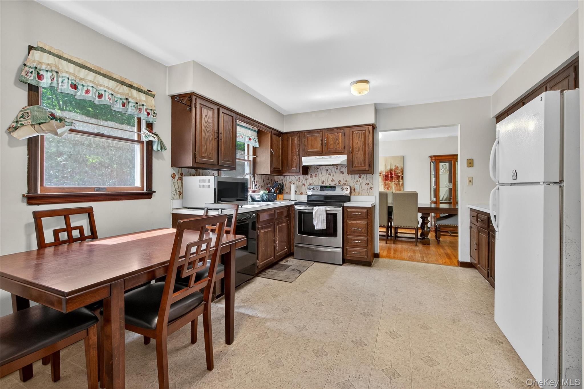300 Estrada Road Central Valley, NY 10917 - Photo 28 of 30 a kitchen with a table chairs refrigerator and cabinets