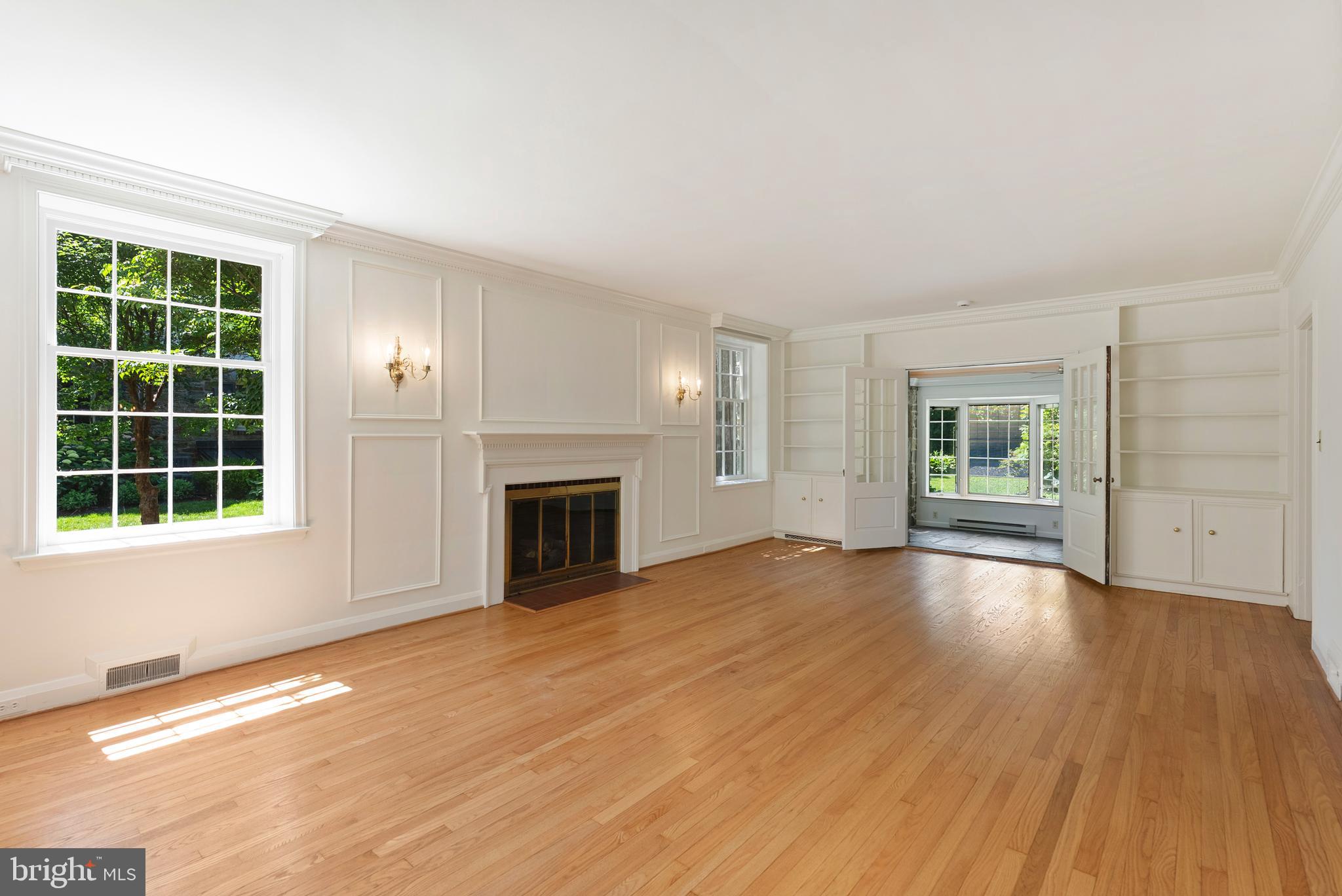 602 Stoneleigh Road Baltimore, MD 21212 - Photo 5 of 31 an empty room with windows fireplace and windows