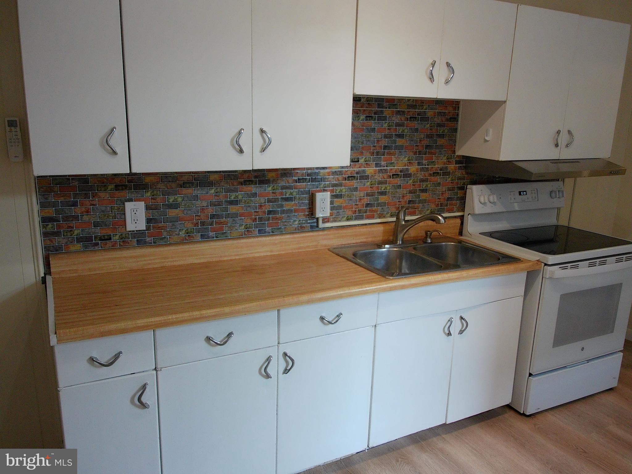 1116 Queen Street Pottstown, PA 19464 - Photo 16 of 48 a kitchen with stainless steel appliances a sink and cabinets
