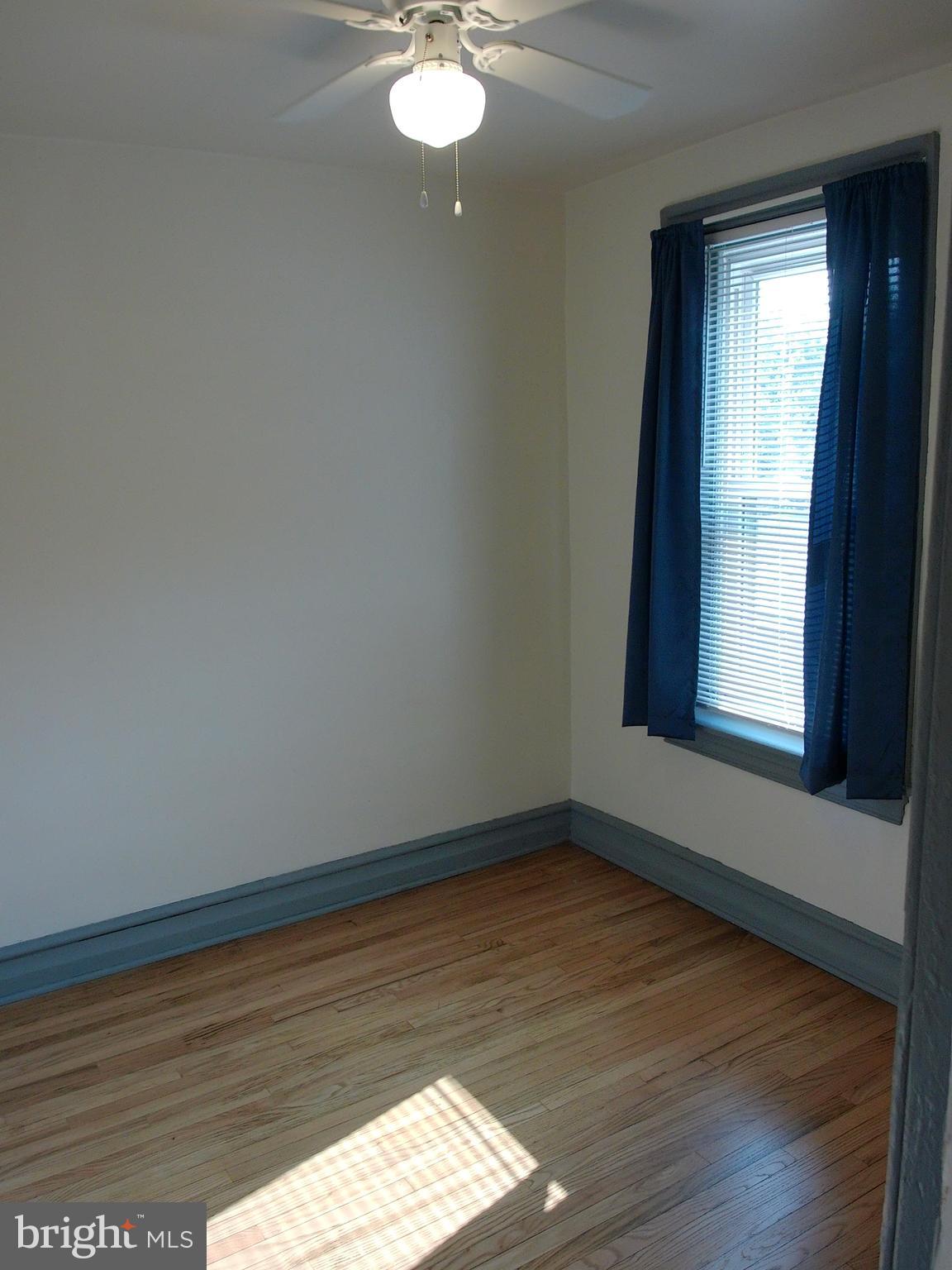 1116 Queen Street Pottstown, PA 19464 - Photo 23 of 48 a view of an empty room with wooden floor and a window