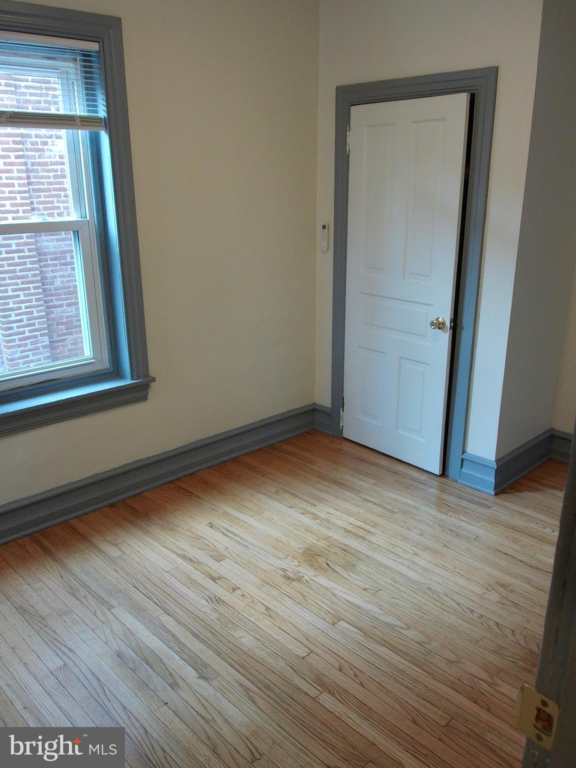 1116 Queen Street Pottstown, PA 19464 - Photo 32 of 48 an empty room with wooden floor and windows
