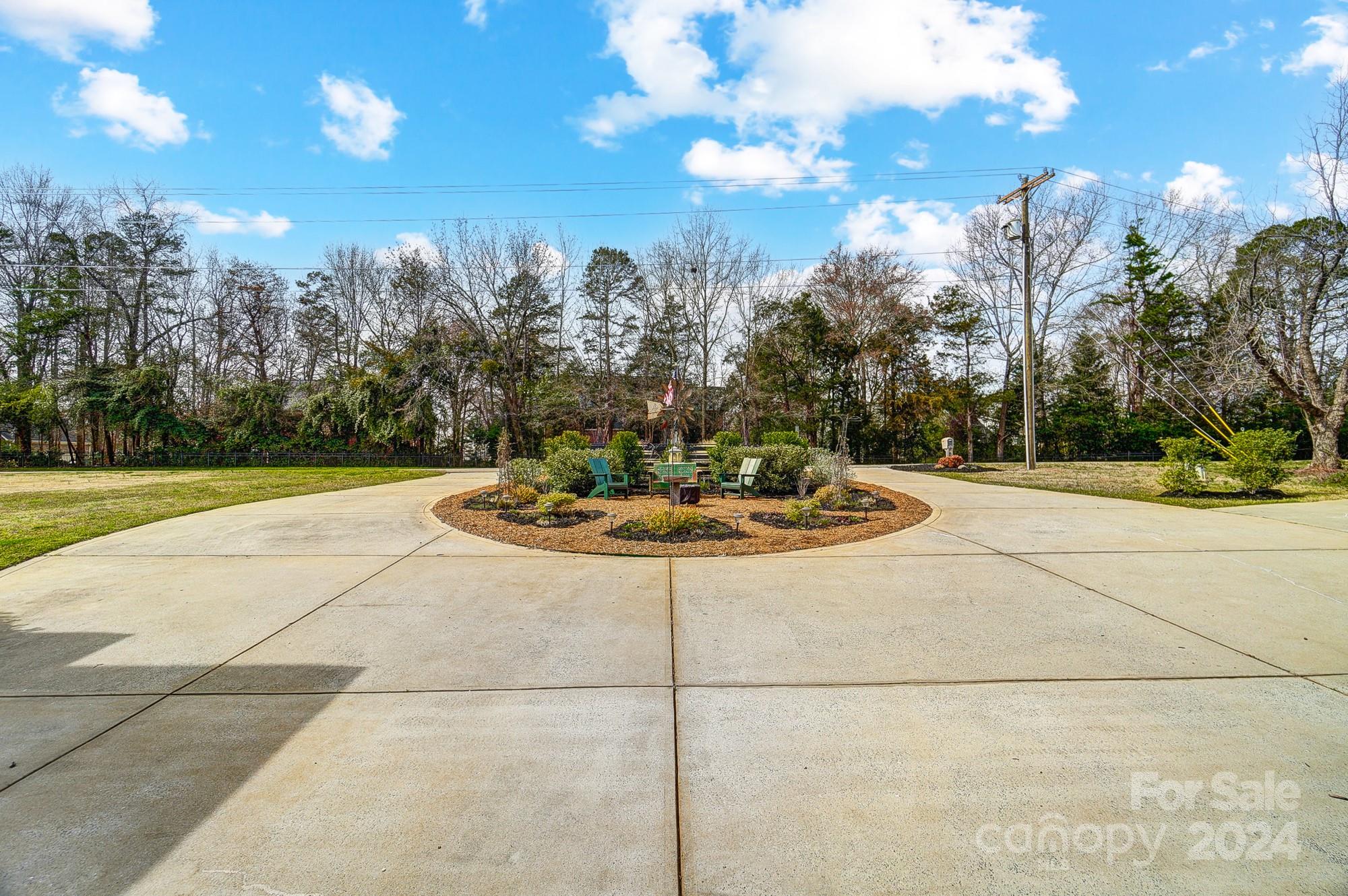 1222 North Dobys Bridge Road Fort Mill, SC 29715 - Photo 3 of 48 a view of a fountain in the middle of a yard