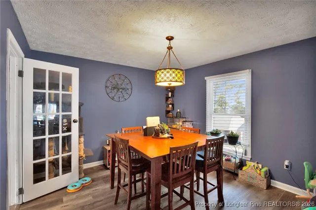 a view of a dining room with a table and chairs