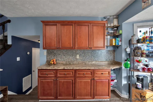 a kitchen with stainless steel appliances granite countertop a sink and cabinets