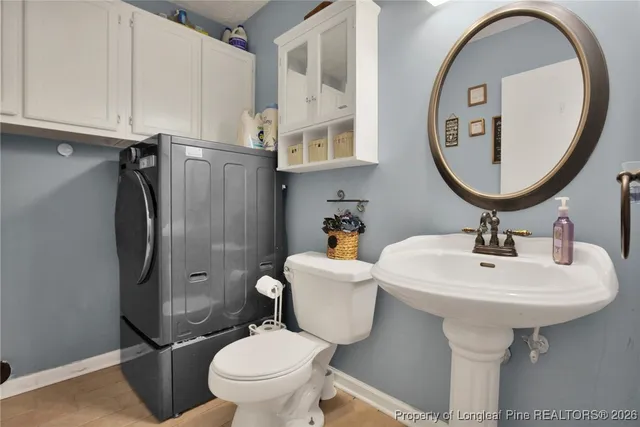 a bathroom with a sink toilet and a mirror