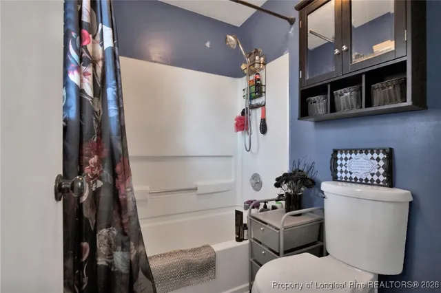 a living room with furniture and a wall painting