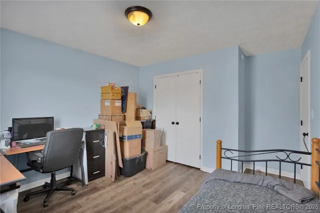a view of a workspace with furniture and wooden floor