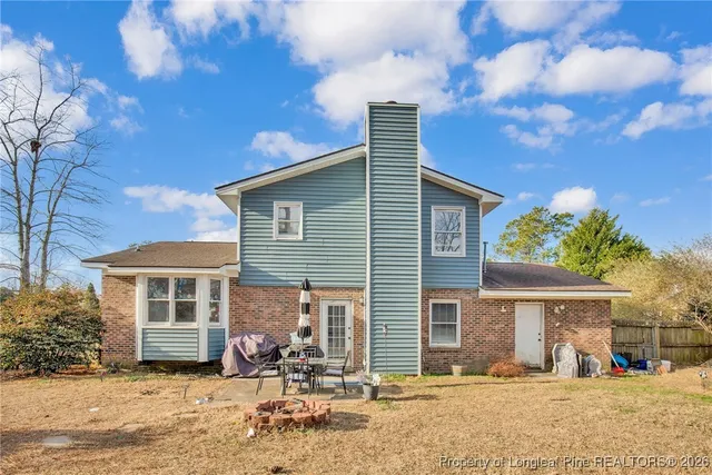 a front view of a house with a yard covered in snow